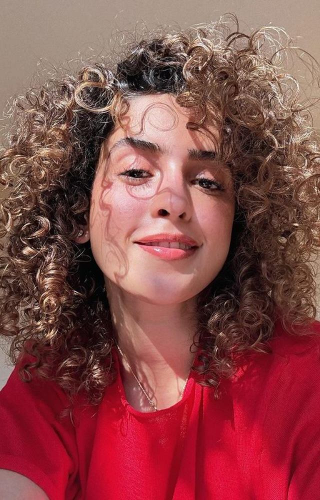 Sanya Malhotra captures perfection, attempting a selfie with her fabulous curly hair, radiating confidence and charm.