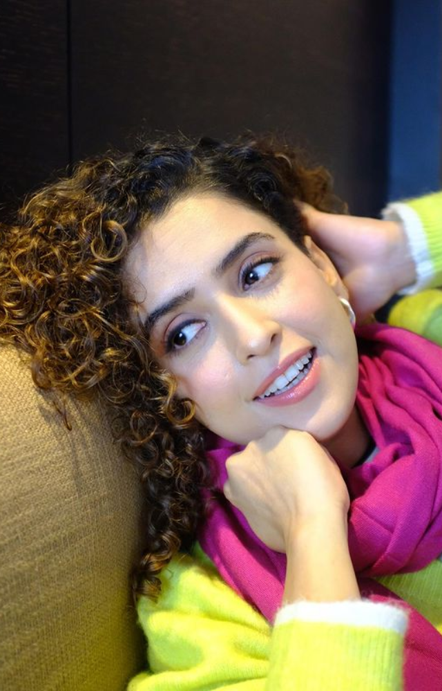 Adorned with a pink stole, Sanya Malhotra epitomizes elegance, the stylish accessory accentuating her chic and fashionable persona.