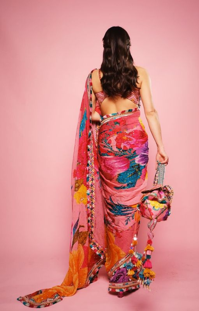 Witness Sara Ali Khan`s floral magic, where each fold tells a story of elegance and vibrancy. A stunning saree showcase.