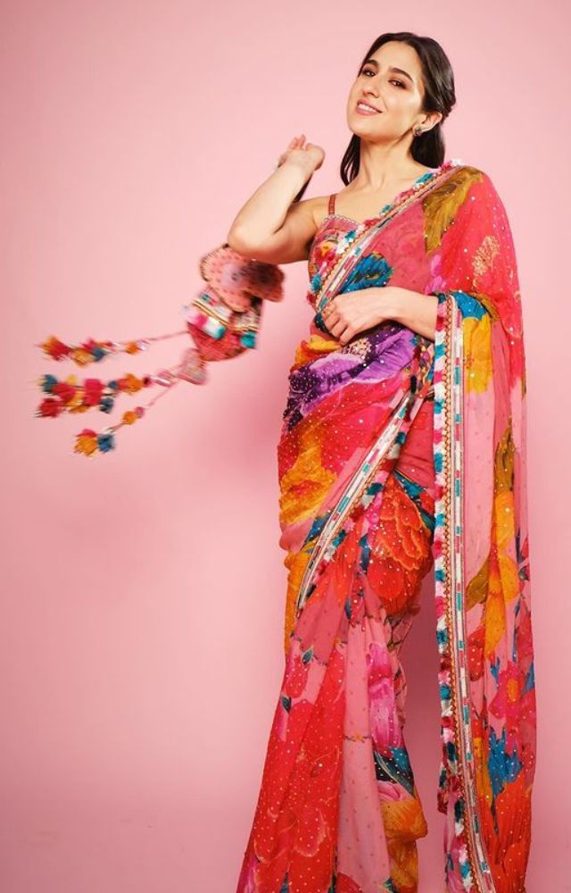 Sara embraces grace in a floral saree, epitomizing beauty with every petal. A captivating blend of tradition and modern charm.