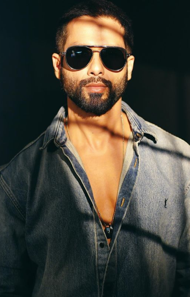 In a stylish fusion, Shahid Kapoor combines blue denim and black shades, showcasing a suave and fashion-forward ensemble.