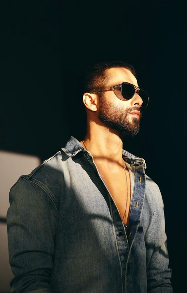 Embracing casual coolness, Shahid sports blue denim and black shades, exuding a laid-back yet strikingly stylish demeanor.