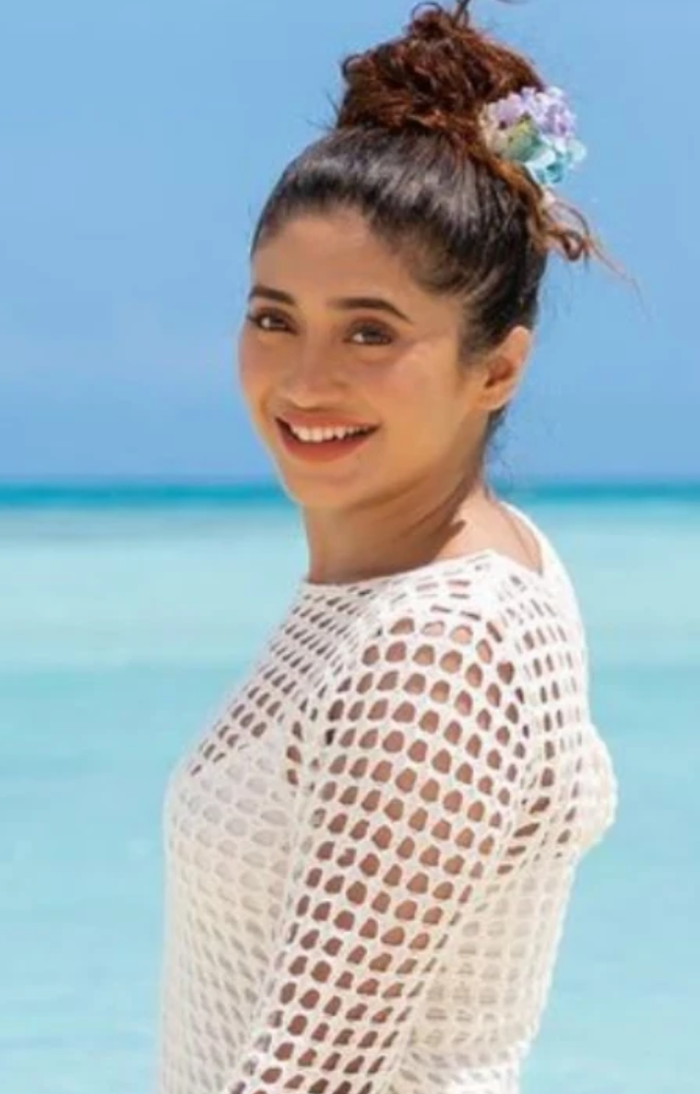 Enjoy the classic style of a white one-piece dress with this summer fashion collection from actress Shivangi Joshi