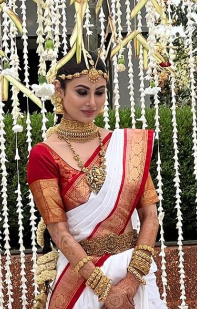 On her big day, Mouni Roy wore a white saree accented with a red border.