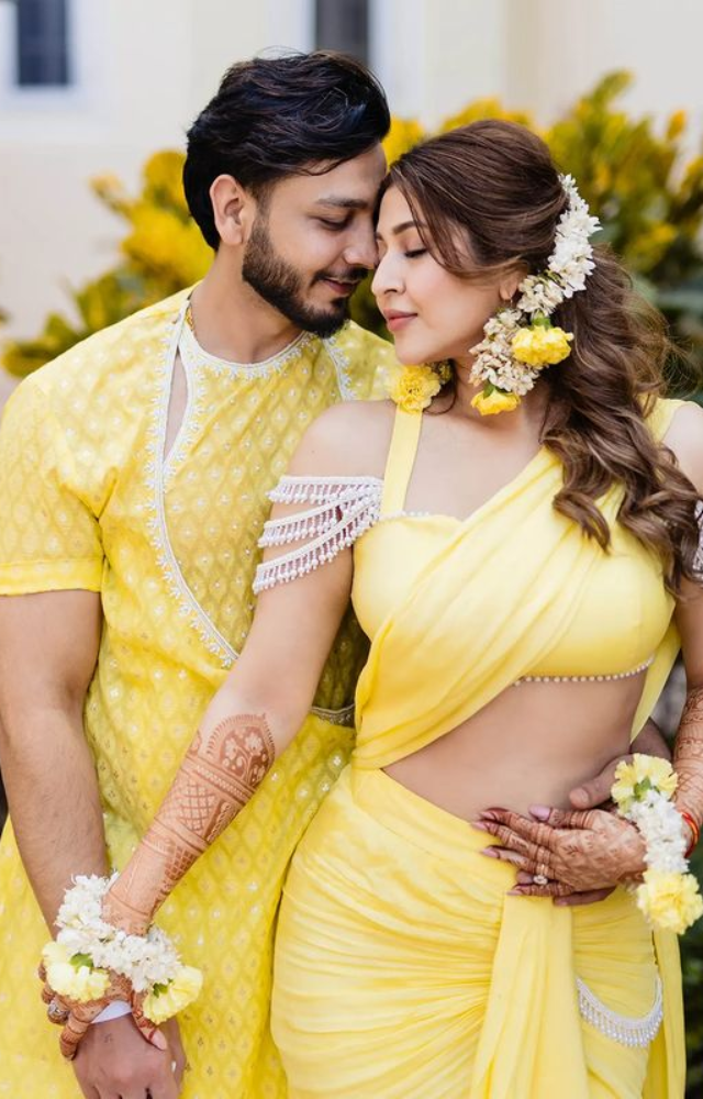 A lovely couple strikes a snug pose during their haldi ceremony photoshoot.