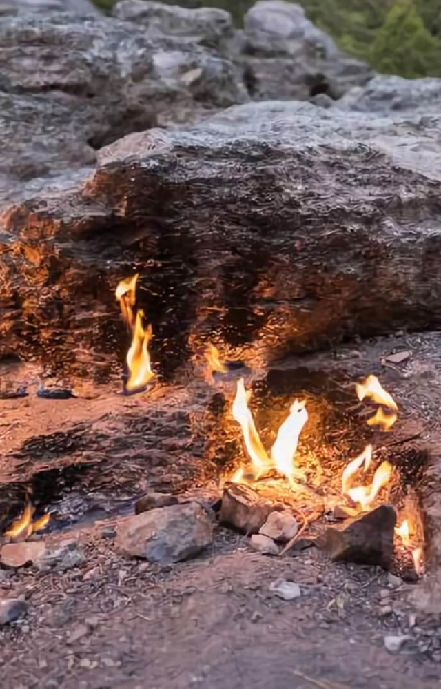 This ancient mountain breathes fire through rock cracks. Its natural gas flames have burned for over 2,000 years, inspiring ancient myths.

