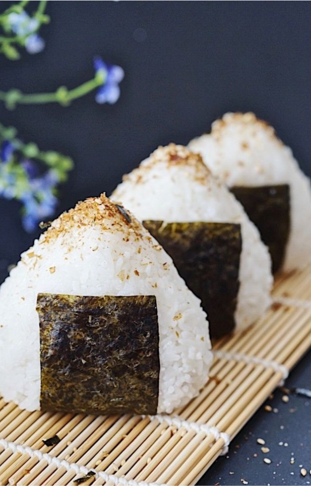 Simple rice balls wrapped in seaweed, often with fillings like pickled plum or seasoned veggies.
