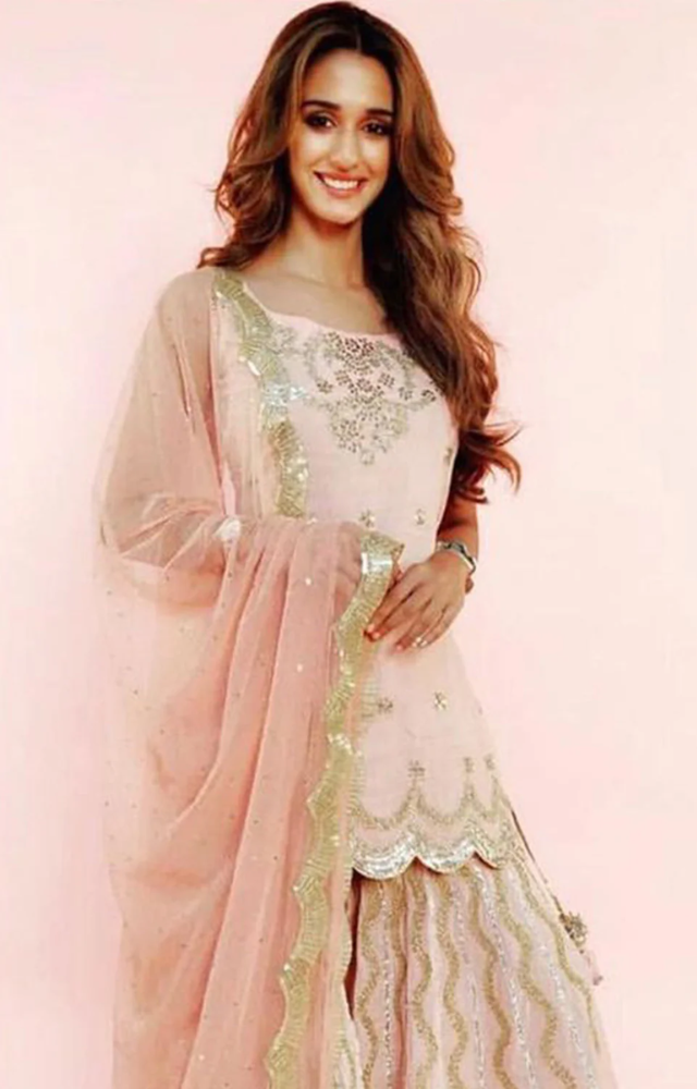 Disha Patani’s blush pink sharara exudes elegance and charm. A dreamy choice for a graceful Eid celebration!