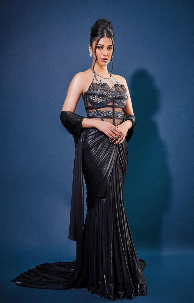 She exudes grace in a stunning black gown, proving that black is always timeless. A flawless choice for red-carpet moments!