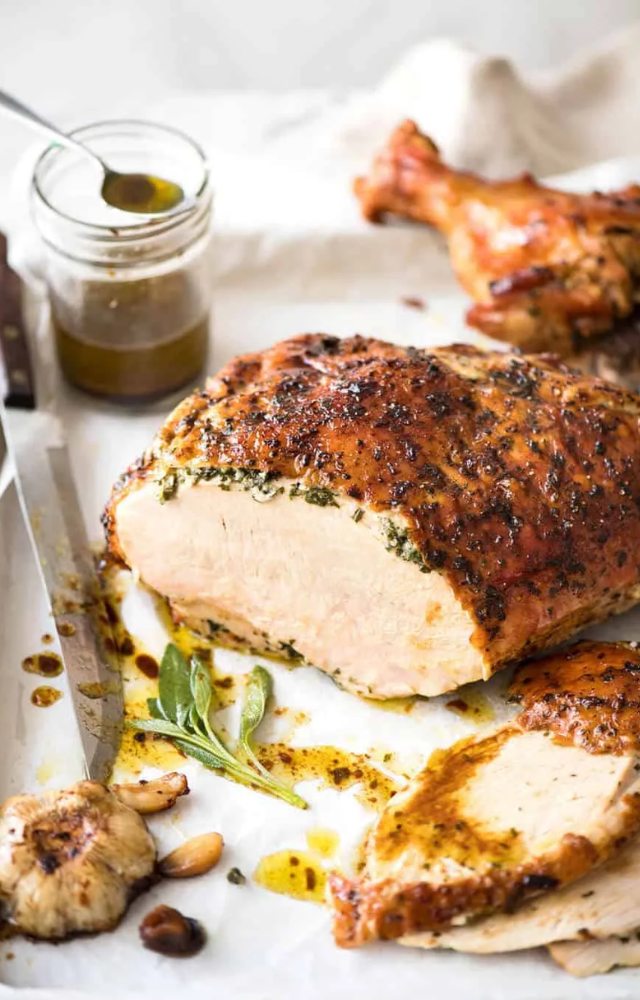 A golden-brown turkey with herb butter makes for a juicy, festive centerpiece.