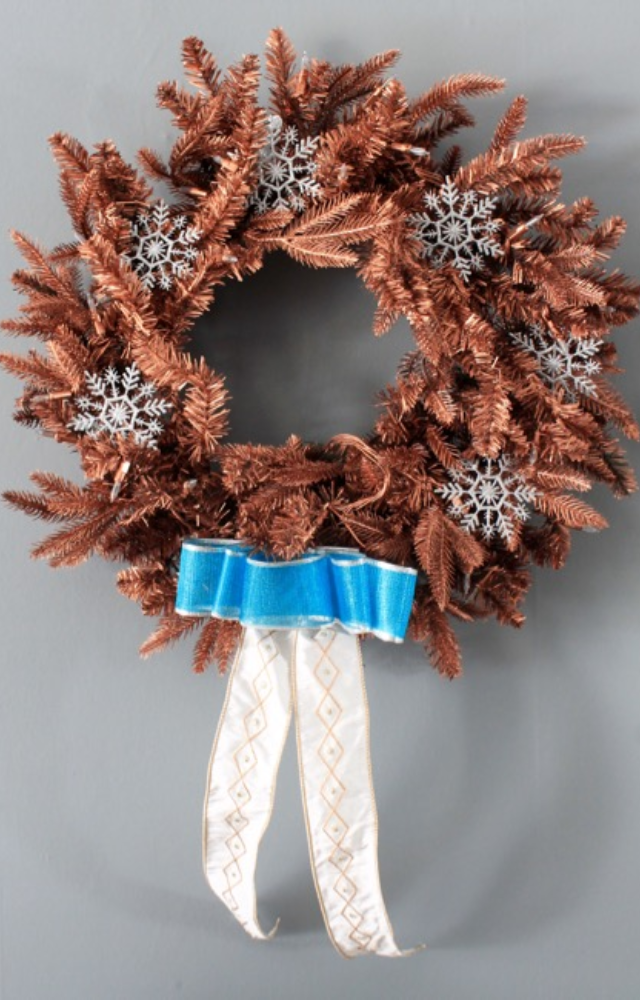 Welcome guests with stunning wreaths adorned with ribbons, pinecones, and berries.