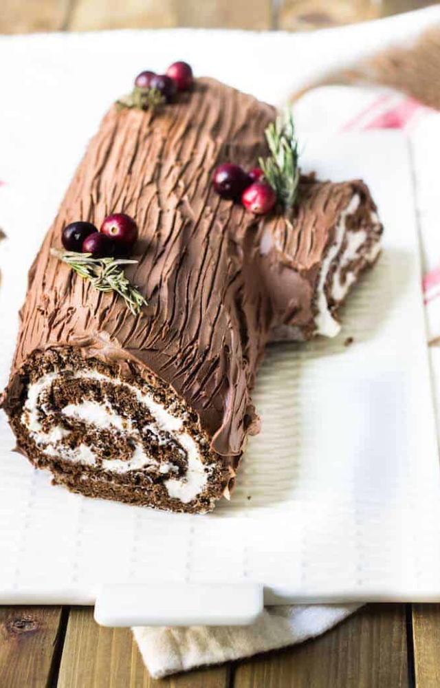 A rolled cake decorated like a log, covered with chocolate ganache for a festive touch.