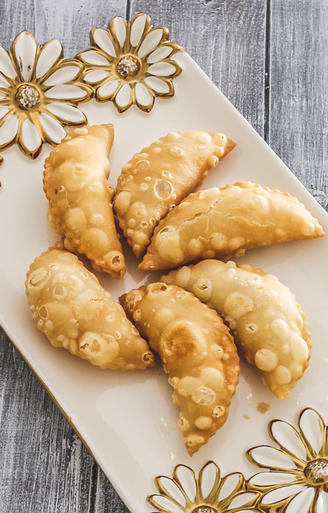 Sweet pastries filled with coconut and jaggery, deep-fried for a delightful crunch.