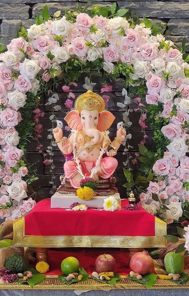 Create a stunning backdrop for your Ganesh idol using fresh flowers like marigolds, roses, and jasmine, adding a vibrant and fragrant touch to your décor.

