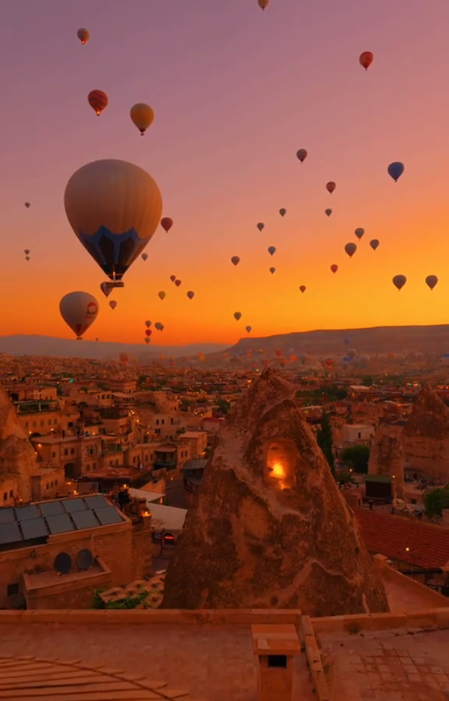 Fairy-tale chimneys and sunrise hot-air balloons create a landscape straight out of a storybook.
