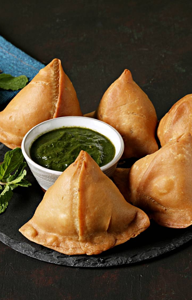 A crispy triangular classic filled with spiced potatoes—nothing says chai time like a hot samosa.