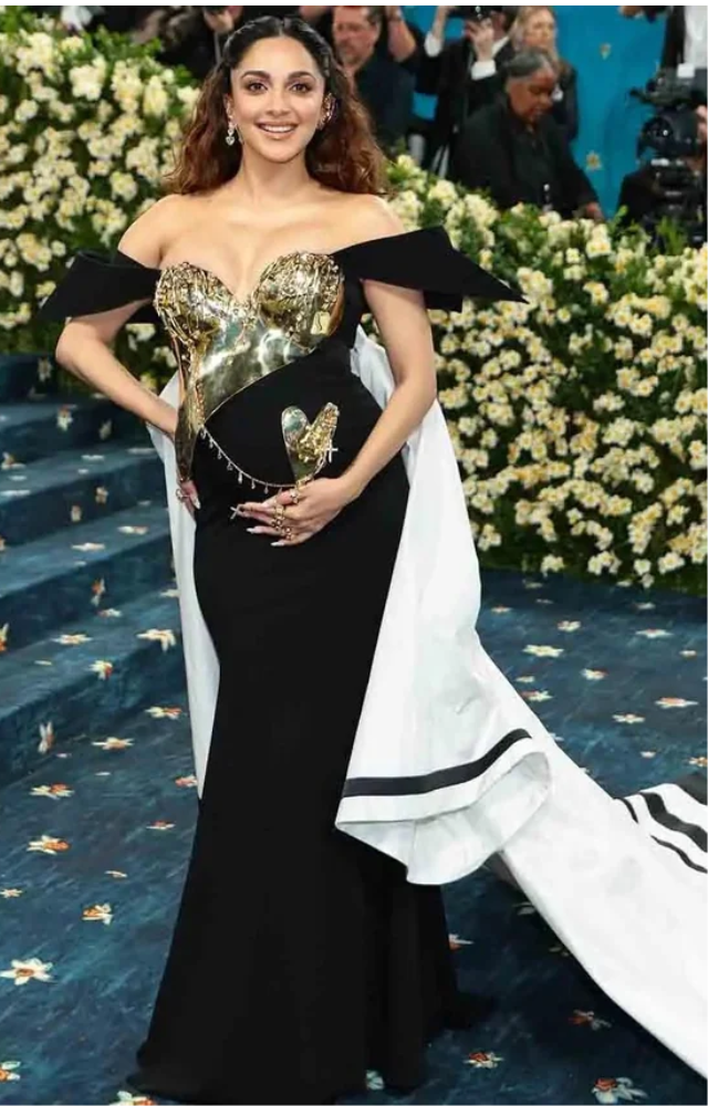 Kiara Advani debuted her baby bump at Met Gala 2025 in a sculpted Gaurav Gupta gown, embracing the theme with grace and futuristic elegance.
