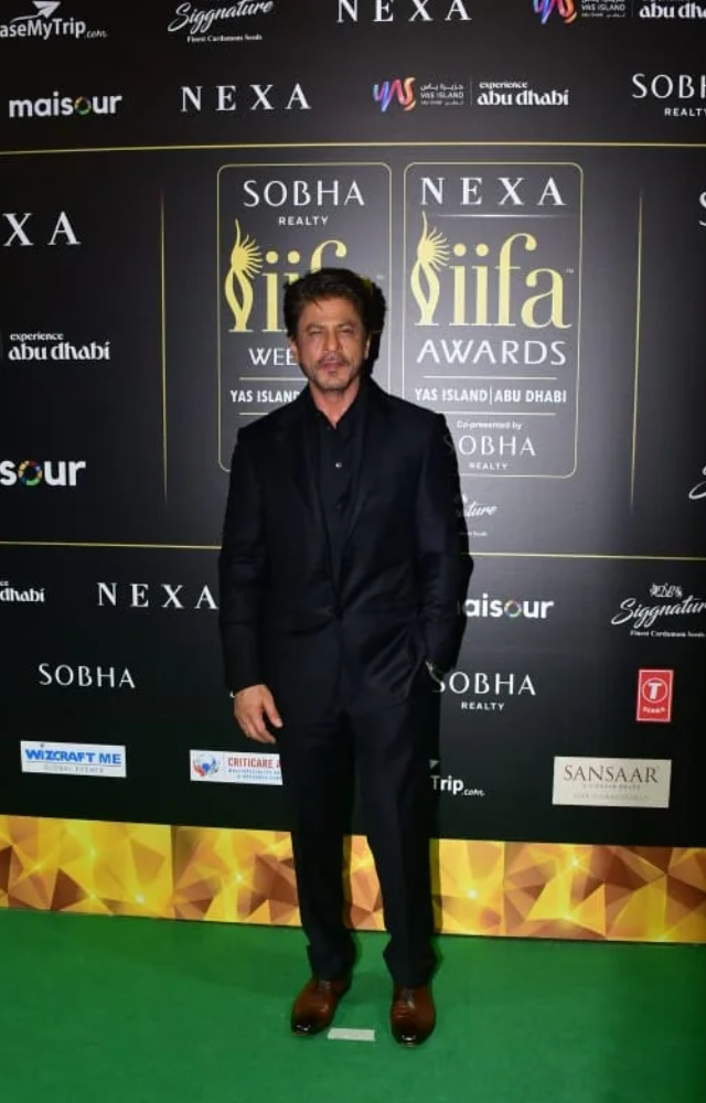 The King of Bollywood kept it classic in a sleek black tuxedo, radiating timeless charm.