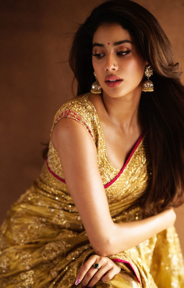 With her golden saree and matching accessories, Janhvi brings a touch of glamour to traditional wear, making a stunning statement.
