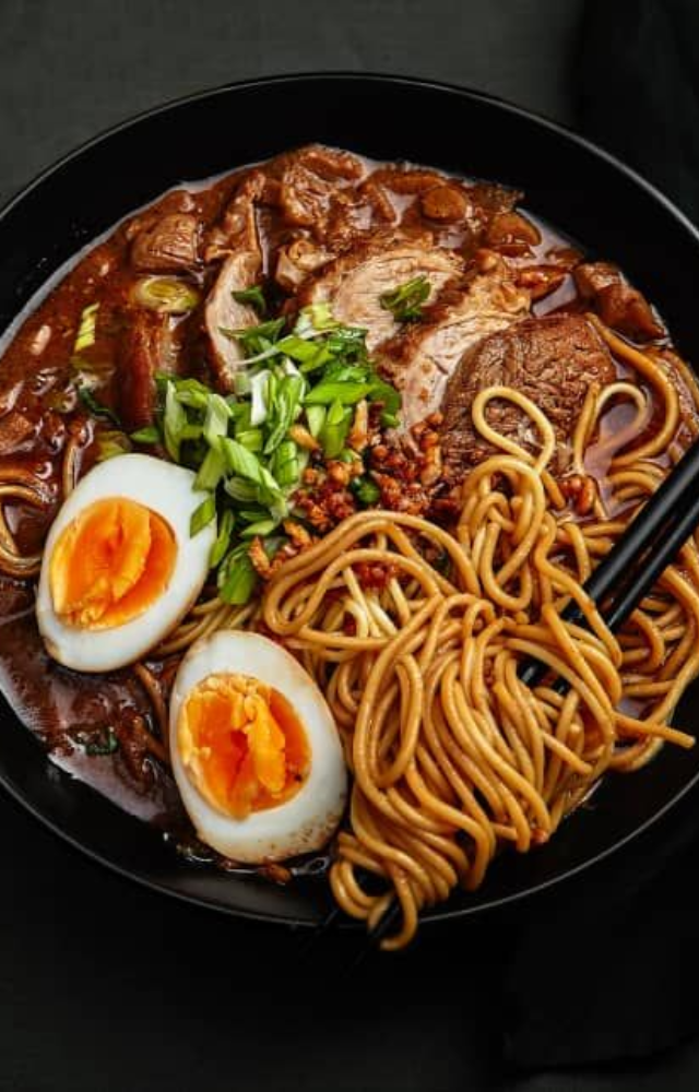 A rich, comforting noodle soup packed with umami, served with meat, eggs, and veggies in a flavorful broth.
