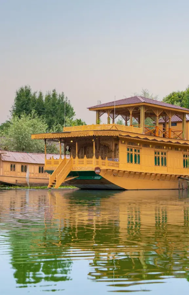 Float on the Dal Lake in elaborately carved wooden houseboats, a timeless Kashmiri tradition. Serene views and warm hospitality await.
