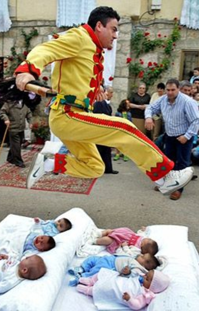 Men dressed as devils leap over rows of babies to cleanse them of sin. This 400-year-old ritual is still performed every year in Castrillo de Murcia.
