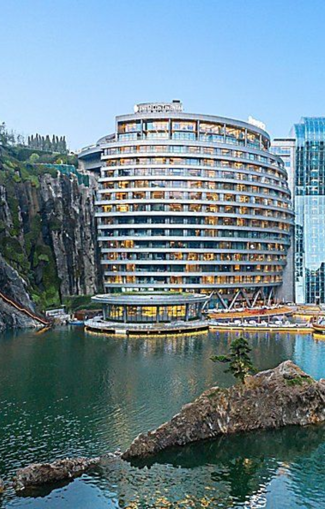 Built into an abandoned quarry, this hotel features waterfalls flowing down rock walls inside its glass-wrapped structure.
